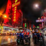 Tuk-tuks on a Bangkok Chinatown street, Thailand, illustrating local evening activities