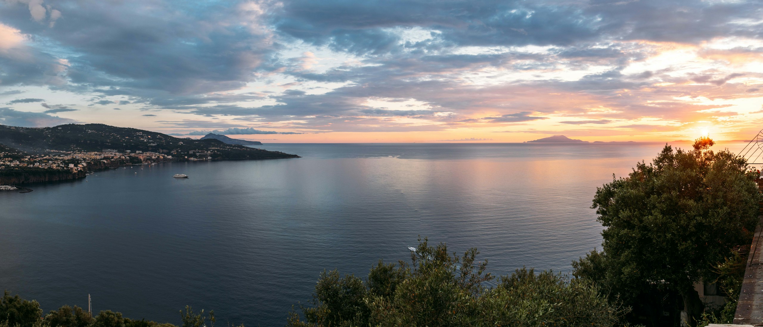 Panoramic coastal town and bay at sunset