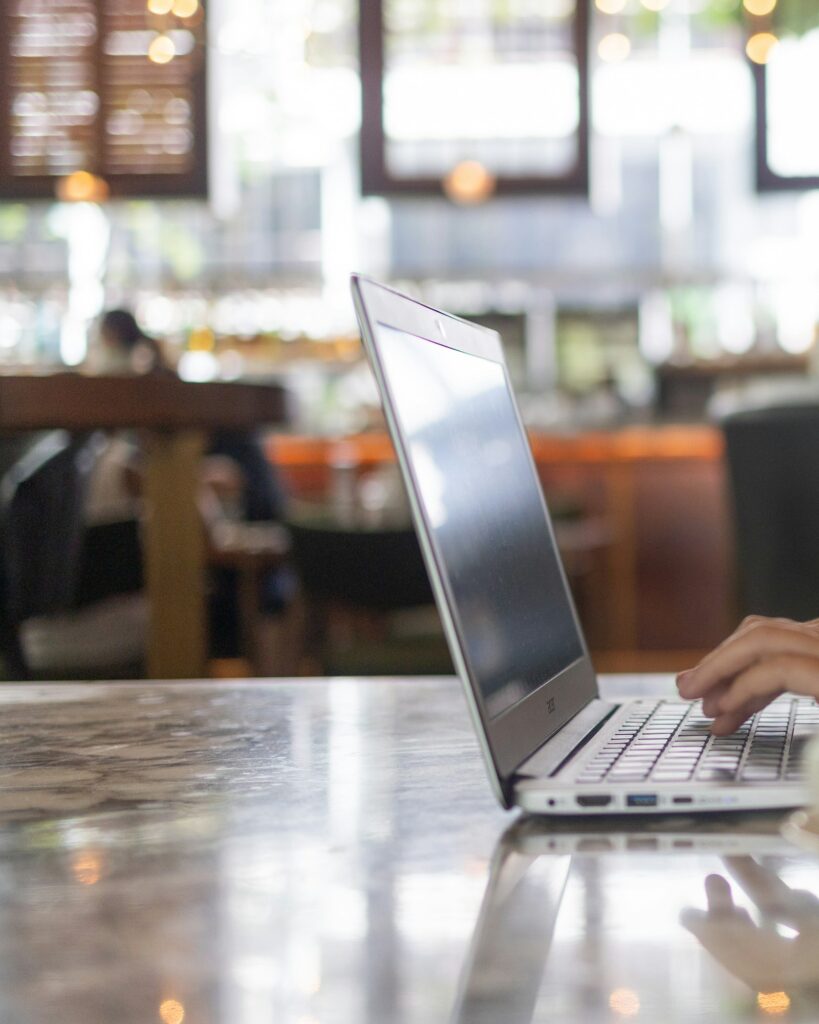 Remote worker using a laptop in a city cafe
