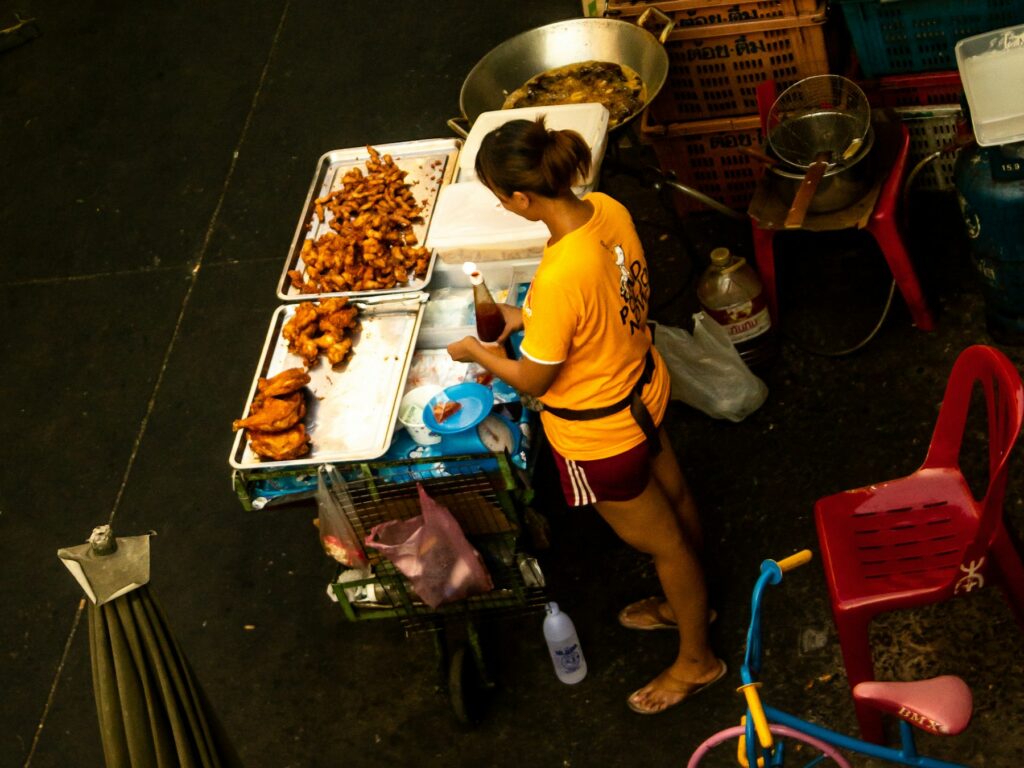 Local street food vendor preparing food at a market stall