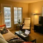 Furnished apartment living room with a laptop for a long-stay rental checklist