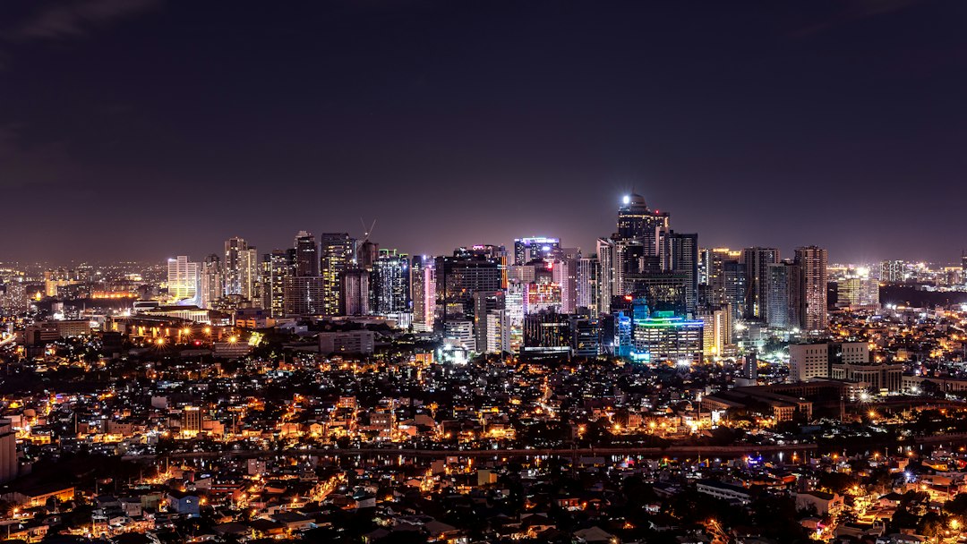 Makati skyline at night in Metro Manila Philippines to compare Manila and Cebu for long stays