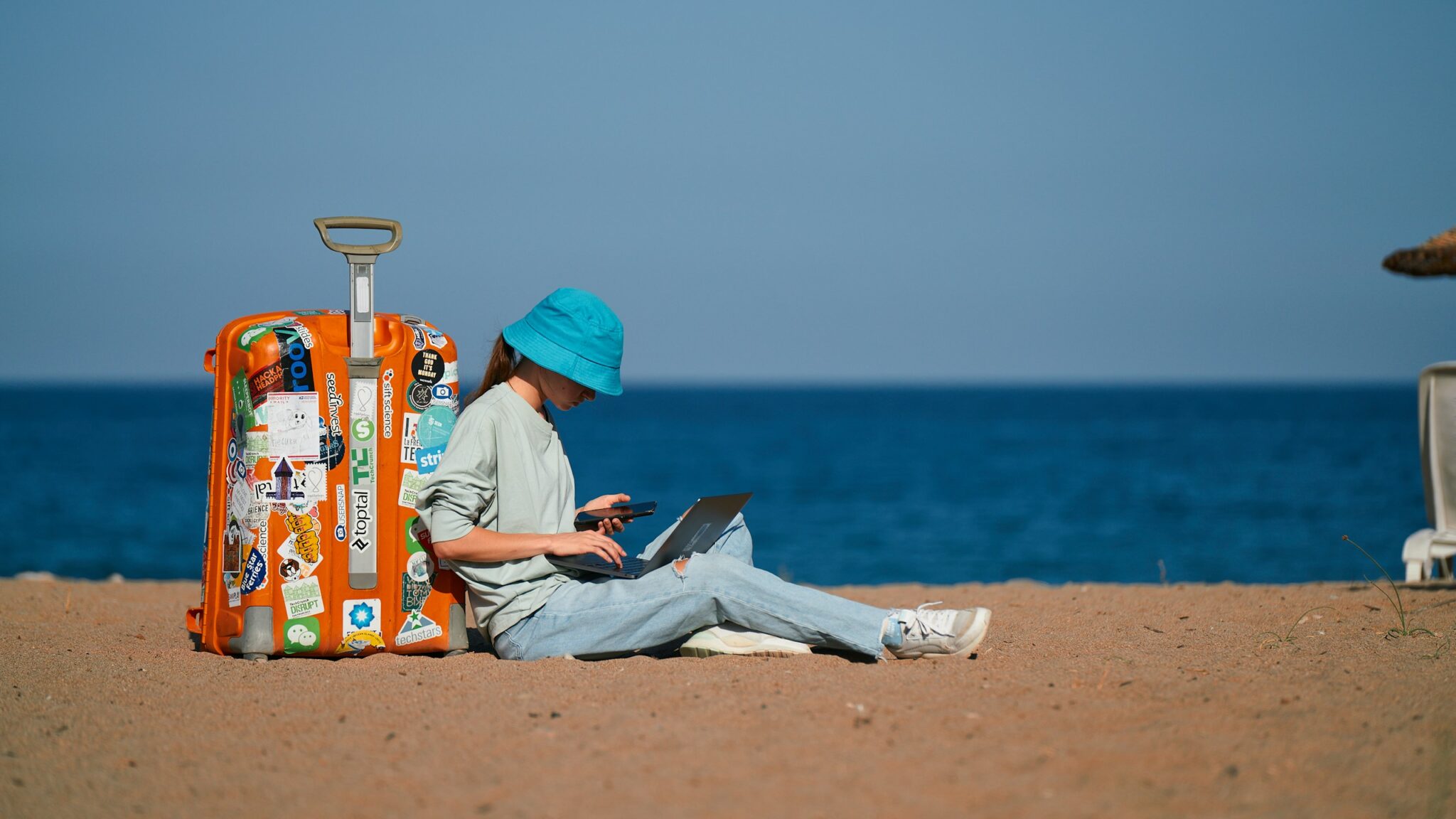 Remote worker using a laptop beside the beach while traveling