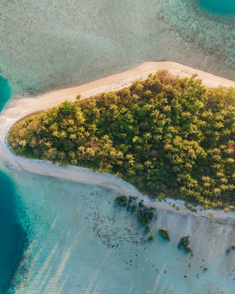 Aerial tropical island surrounded by turquoise water