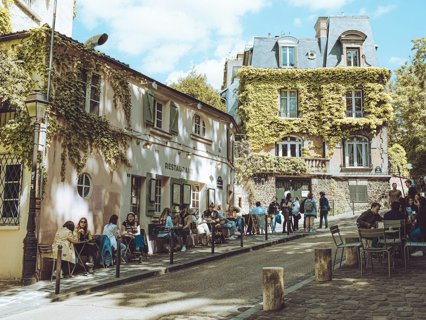 People enjoying an outdoor cafe in a walkable neighborhood